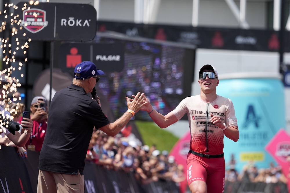 Matthew Marquardt celebrating IRONMAN Lake Placid finish with Mike Reilly